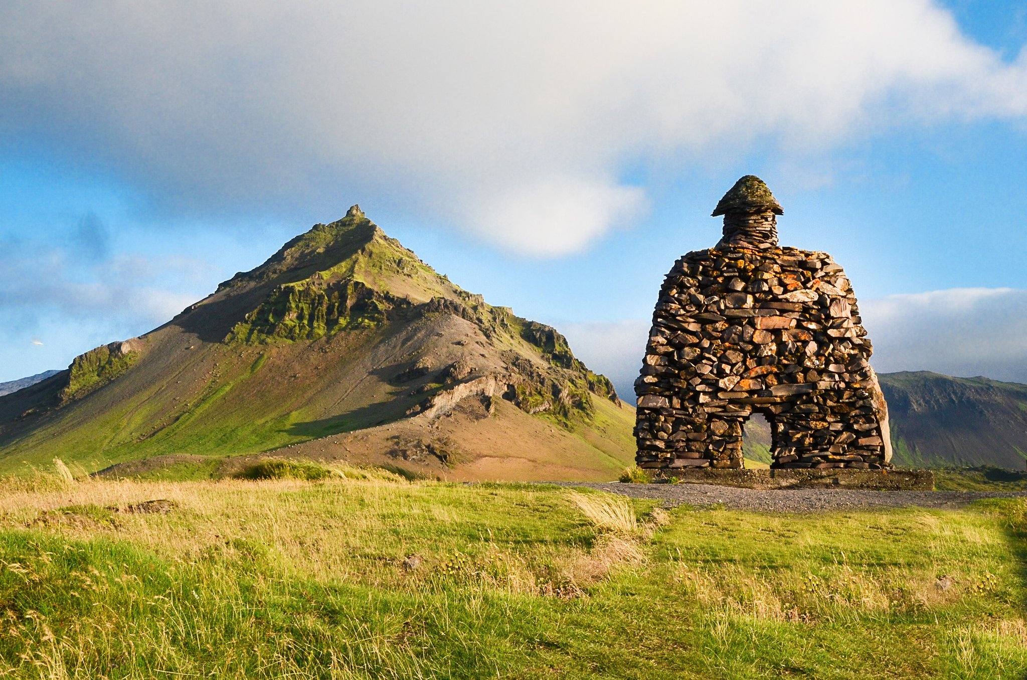 The stone statue of Bárður Snæfellsás at Arnarstapi, with Stapafell behind