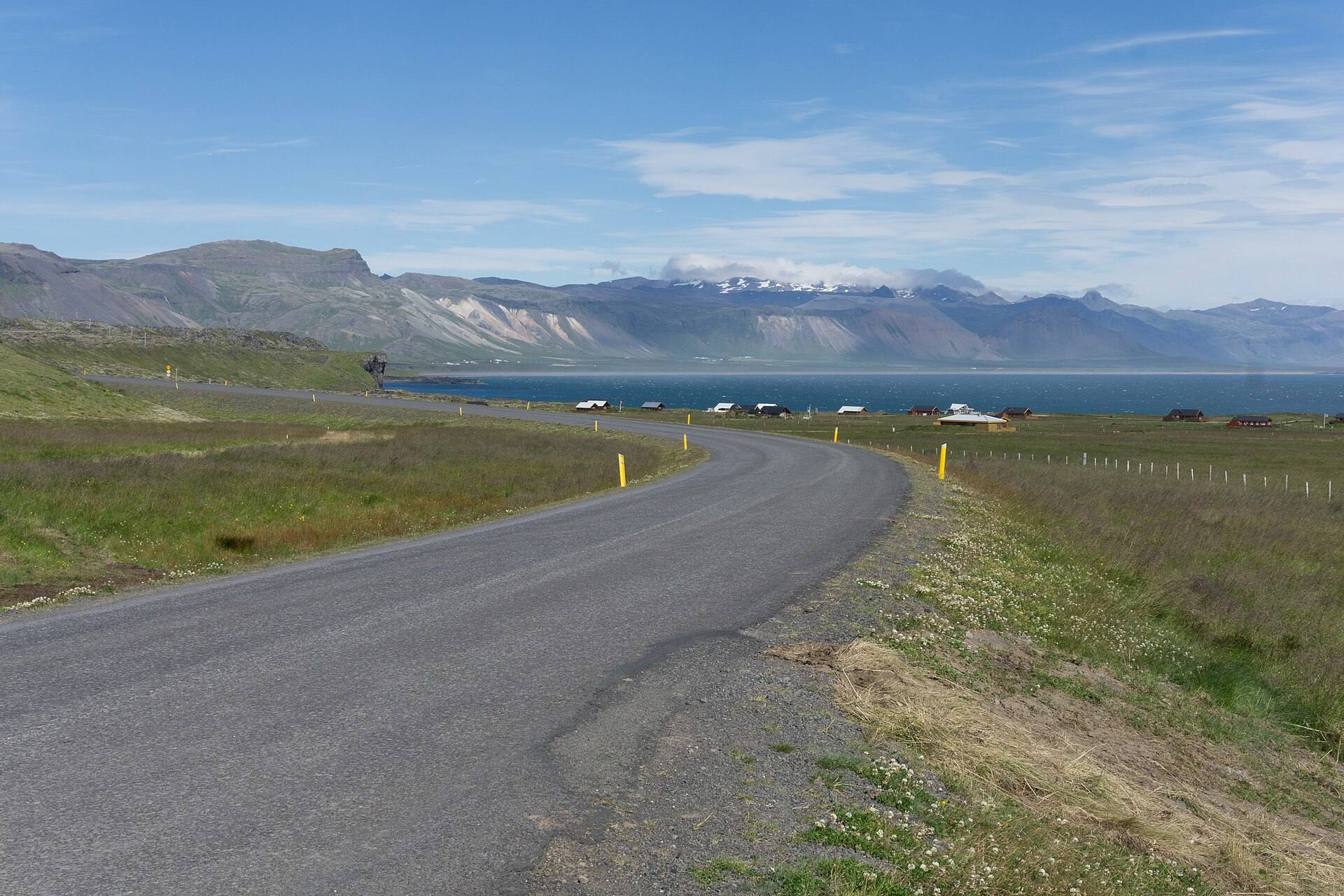 Road 574 curving through green fields near Arnarstapi